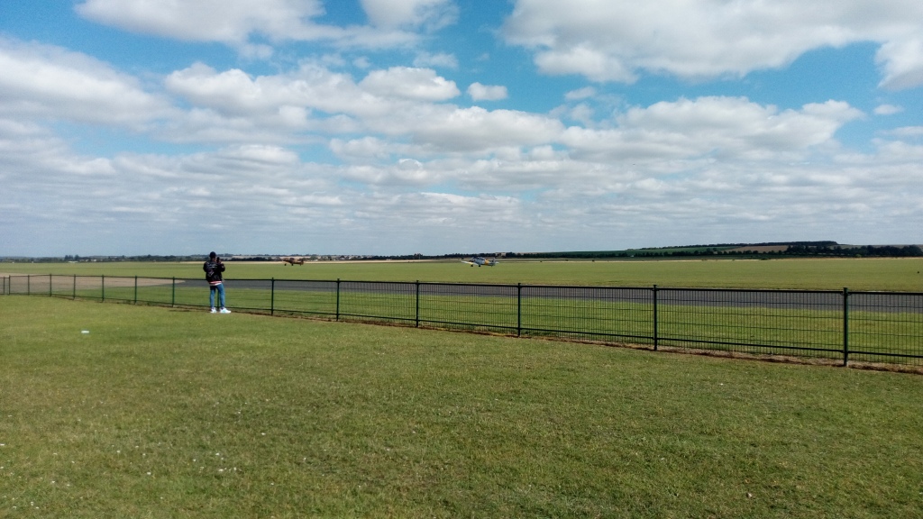A shot of Duxford Airfield, Taken by Inky, for the planes taking off and the clouds in the horizon